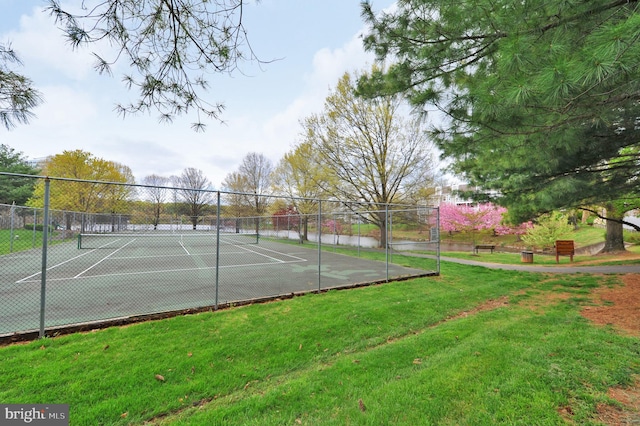 view of sport court featuring a lawn