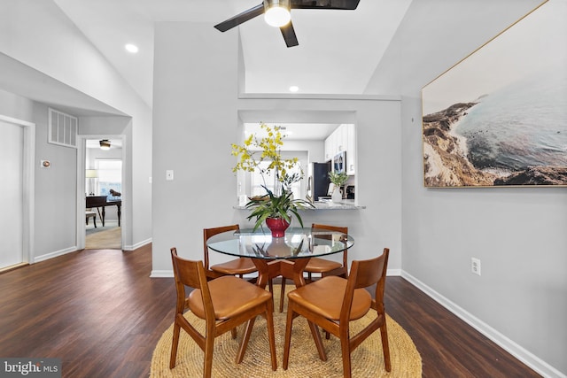 dining space with vaulted ceiling, dark wood-type flooring, and ceiling fan