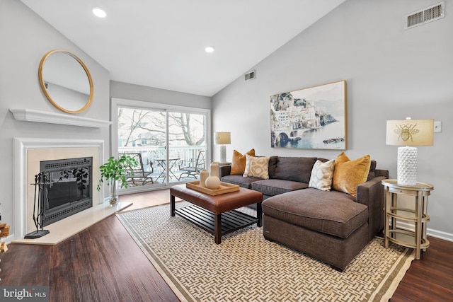 living room featuring dark wood-type flooring and vaulted ceiling