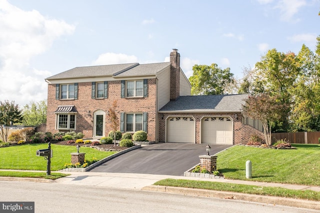 colonial-style house with a garage and a front yard