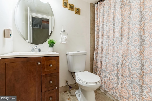 bathroom featuring tile patterned flooring, vanity, curtained shower, and toilet