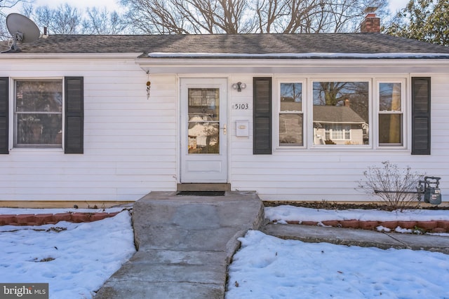 view of snow covered property entrance