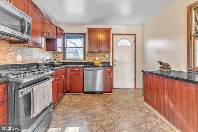 kitchen with tasteful backsplash and appliances with stainless steel finishes