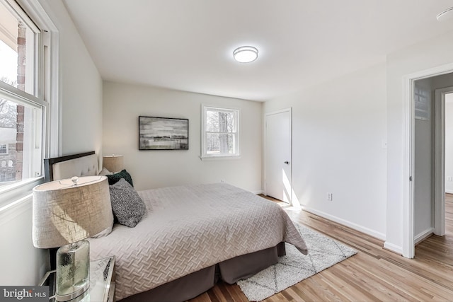 bedroom with wood finished floors and baseboards