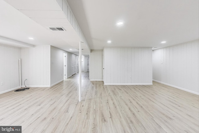 finished below grade area with recessed lighting, visible vents, baseboards, and wood finished floors