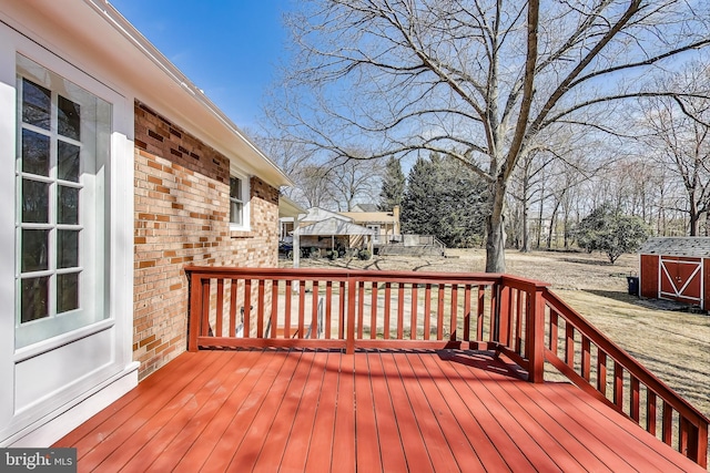 wooden terrace with an outbuilding