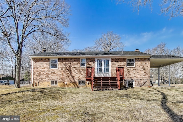 rear view of house featuring brick siding and a chimney