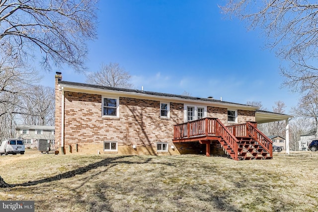 rear view of property with stairs, a wooden deck, brick siding, and a chimney