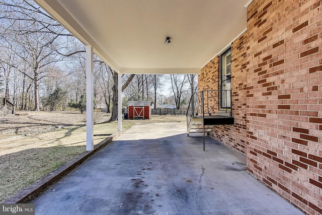 view of patio featuring a storage unit and an outdoor structure