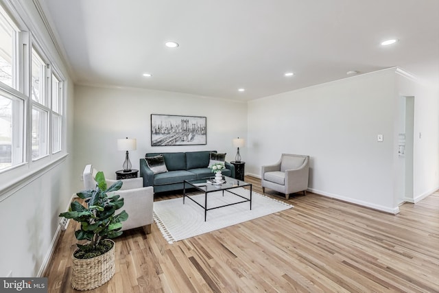 living area featuring recessed lighting, light wood-type flooring, baseboards, and ornamental molding