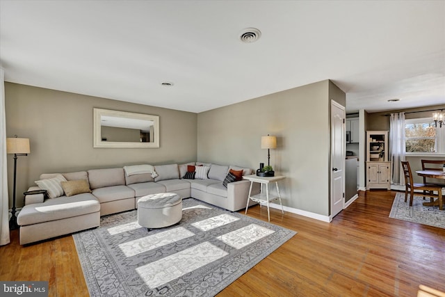 living room featuring hardwood / wood-style floors and a notable chandelier