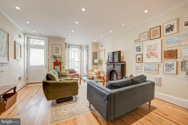 living room featuring crown molding and light hardwood / wood-style floors