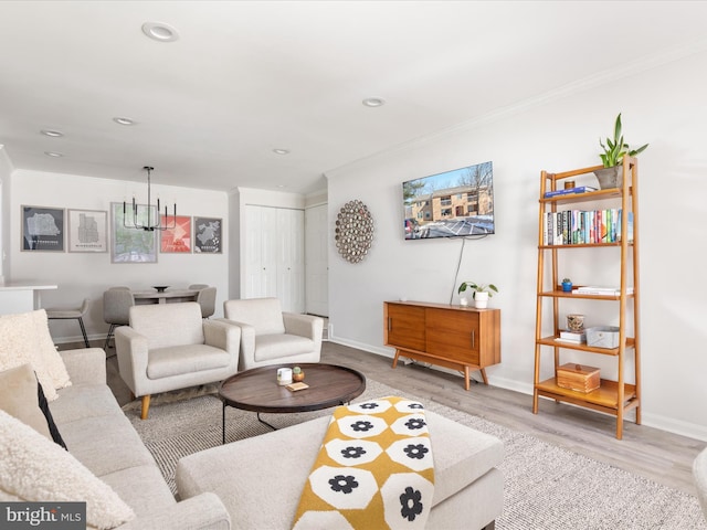 living room with crown molding and light hardwood / wood-style flooring