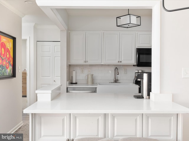 kitchen featuring sink, crown molding, dishwasher, white cabinets, and decorative backsplash