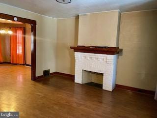 unfurnished living room with dark wood-type flooring and a fireplace