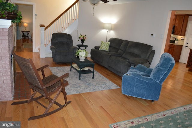 living room with ceiling fan and light hardwood / wood-style floors