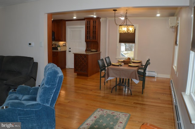 dining room with crown molding, a chandelier, a wall mounted AC, light hardwood / wood-style flooring, and a baseboard radiator