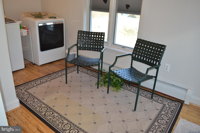 living area featuring hardwood / wood-style floors and washer and dryer