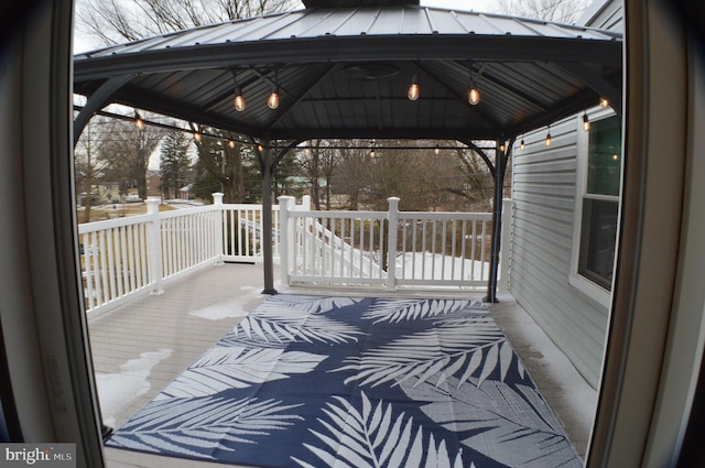 snow covered deck featuring a gazebo