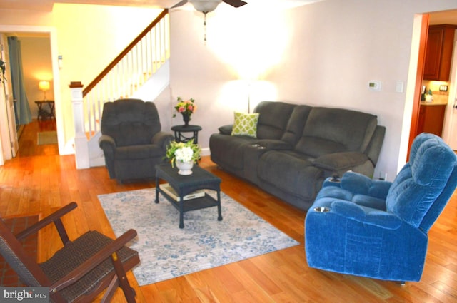 living room featuring ceiling fan and light wood-type flooring