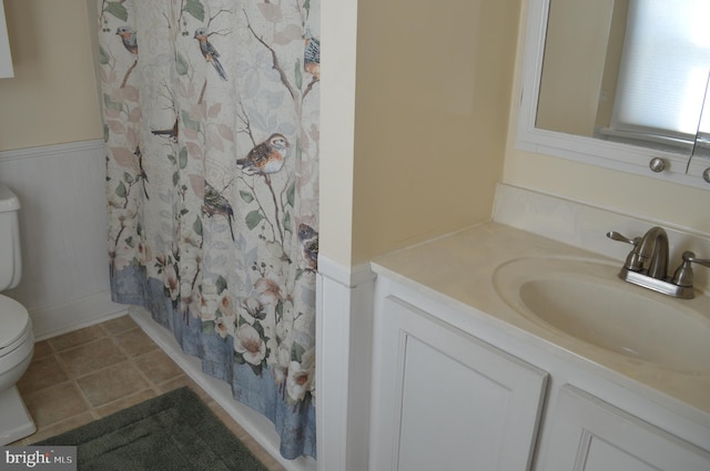 full bathroom with vanity, shower / tub combo with curtain, tile patterned floors, and toilet