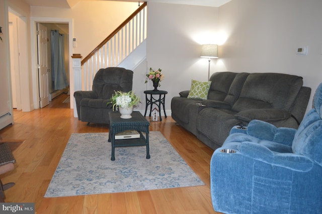 living room with light hardwood / wood-style flooring and a baseboard radiator