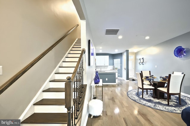 staircase featuring wood-type flooring