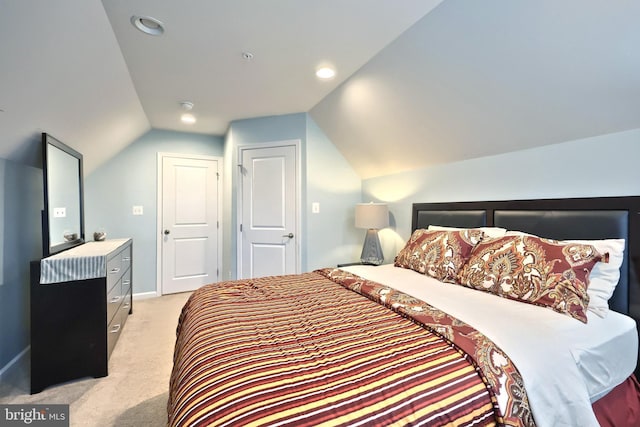 carpeted bedroom with vaulted ceiling