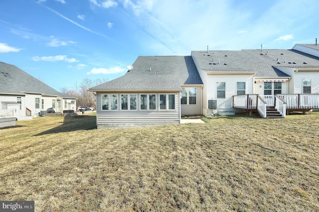 back of house with a wooden deck, a yard, and central AC