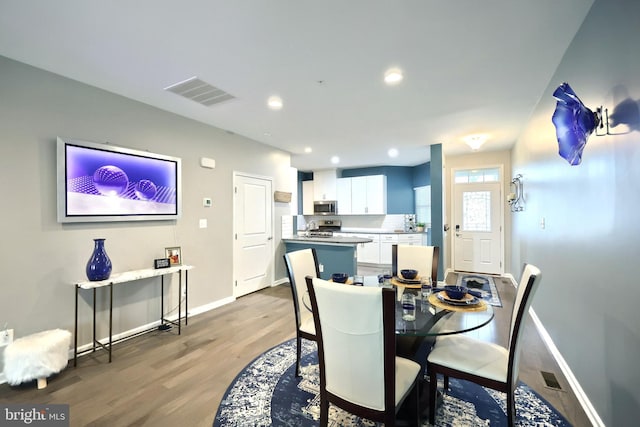 dining room with sink and light hardwood / wood-style floors