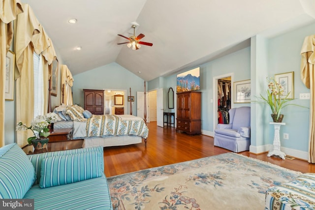 bedroom featuring hardwood / wood-style flooring, ceiling fan, lofted ceiling, and a spacious closet