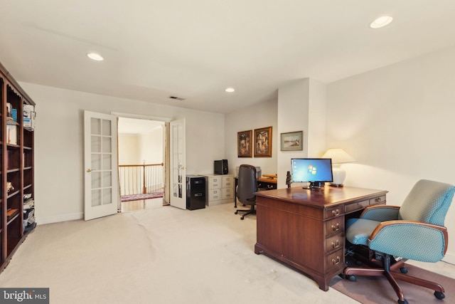 carpeted office space with french doors