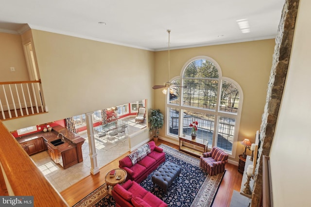 sitting room with sink, crown molding, ceiling fan, and hardwood / wood-style flooring