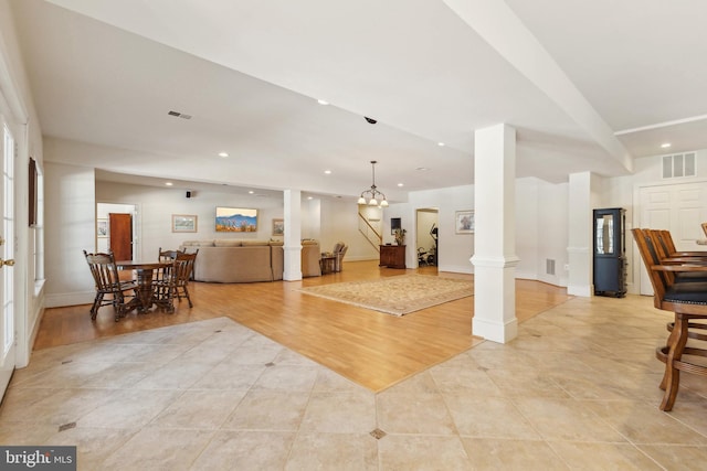 interior space featuring ornate columns and light wood-type flooring