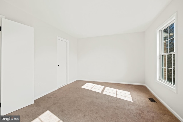 carpeted spare room with a wealth of natural light