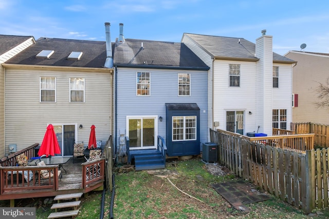 rear view of property with a deck and central air condition unit