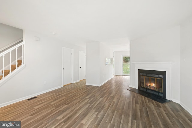 unfurnished living room with dark hardwood / wood-style floors