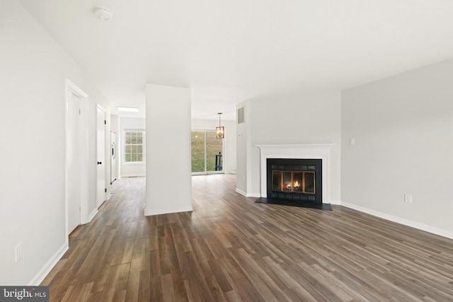 unfurnished living room with dark hardwood / wood-style flooring