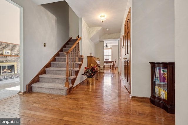 interior space featuring a brick fireplace and light hardwood / wood-style flooring