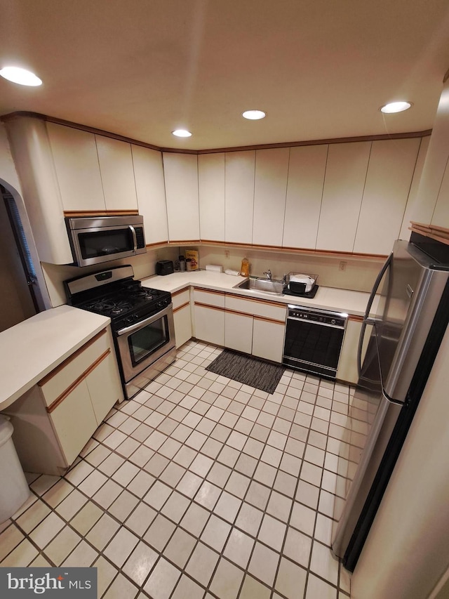 kitchen featuring light tile patterned floors, white cabinets, and appliances with stainless steel finishes