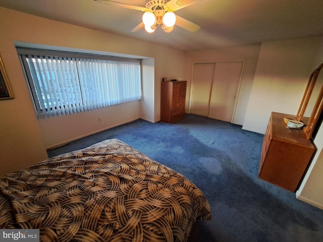 bedroom with dark carpet, a closet, and ceiling fan