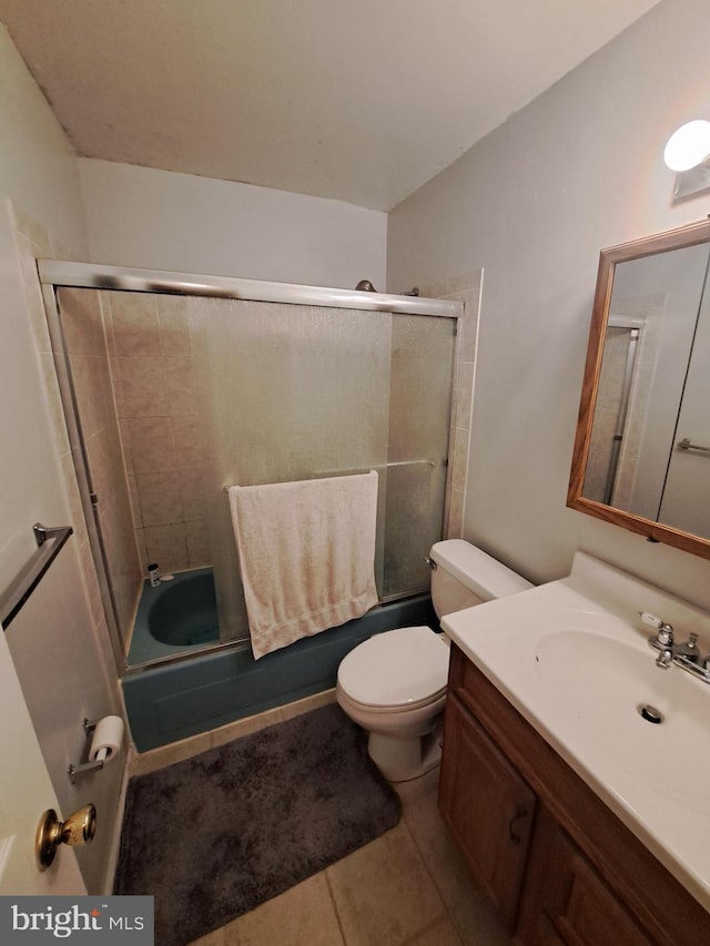 full bathroom featuring vanity, toilet, tile patterned flooring, and combined bath / shower with glass door