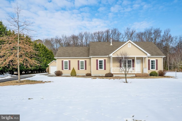 single story home with a garage, an outdoor structure, and a porch