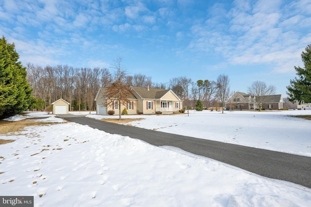 view of front of property with a garage and an outdoor structure