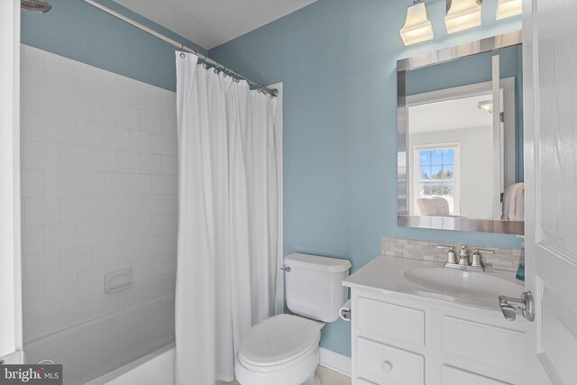 full bathroom featuring shower / tub combo with curtain, vanity, and toilet