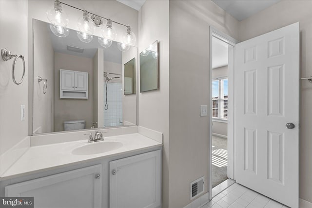 bathroom featuring vanity, tile patterned floors, and toilet