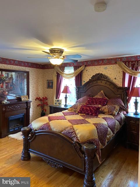 bedroom featuring ceiling fan and hardwood / wood-style floors