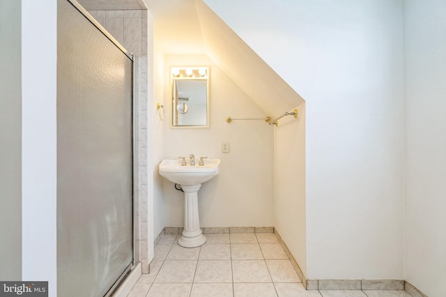 bathroom with walk in shower, tile patterned flooring, and vaulted ceiling