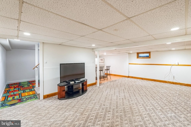 basement featuring carpet and a drop ceiling