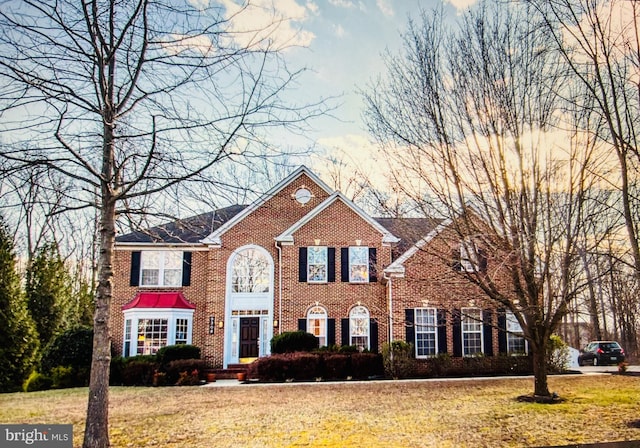 colonial home with a front lawn